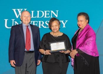 Yvonne D. Greer, DrPH, RD, CD, (center) receives Walden’s Leadership Excellence Award from Board of Directors Chair Toni Freeman (right) and board member Dr. Charlie Heller (left). 