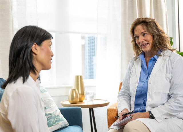 Psychologist in white blouse talks to patient