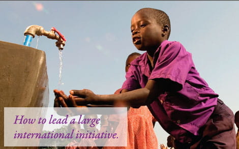 A child in Africa getting water from an outdoor tap.