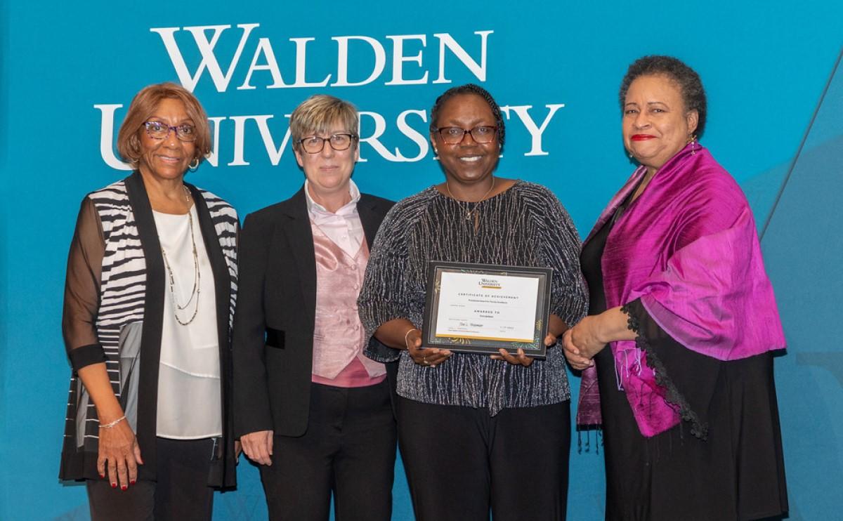 Dr. Cora Jackson receives Walden’s Presidential Faculty Excellence Award from Dr. Anita McDonald, board of directors member; Dr. Sue Subocz, associate president and provost; and Toni Freeman, board of directors chair.