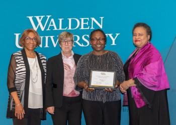Dr. Cora Jackson receives Walden’s Presidential Faculty Excellence Award from (left to right) Dr. Anita McDonald, board of directors member; Dr. Sue Subocz, associate president and provost; and Toni Freeman, board of directors chair.