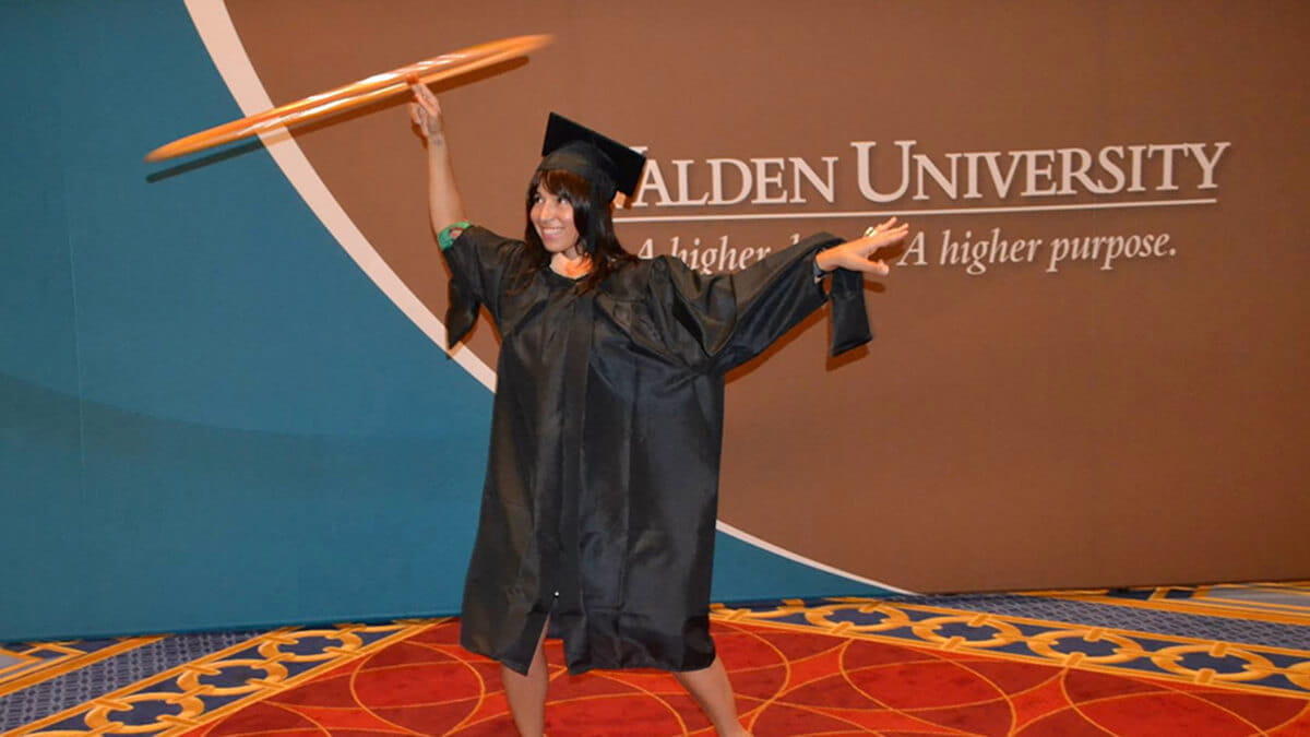 Caroline P. Cárdenas demonstrating hula hoop at graduation.